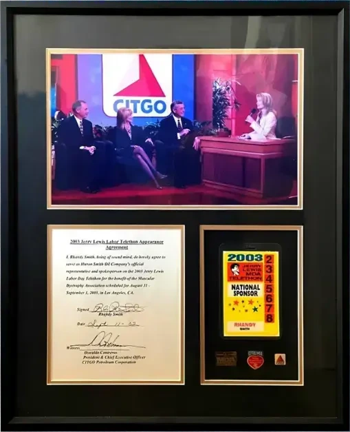 Framed memorabilia featuring a photo of the 2003 Jerry Lewis MDA Telethon with Citgo branding, an official appearance agreement, and a National Sponsor pass.